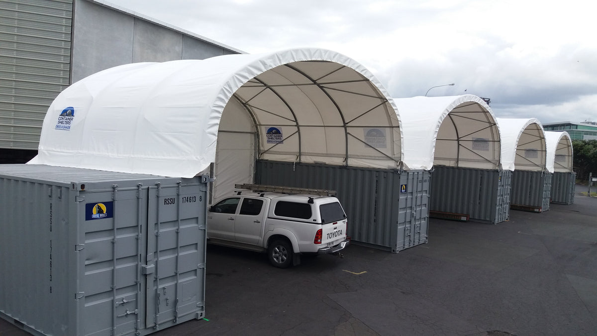 Two 8m x 20ft container shelters side by side at a building supplies yard